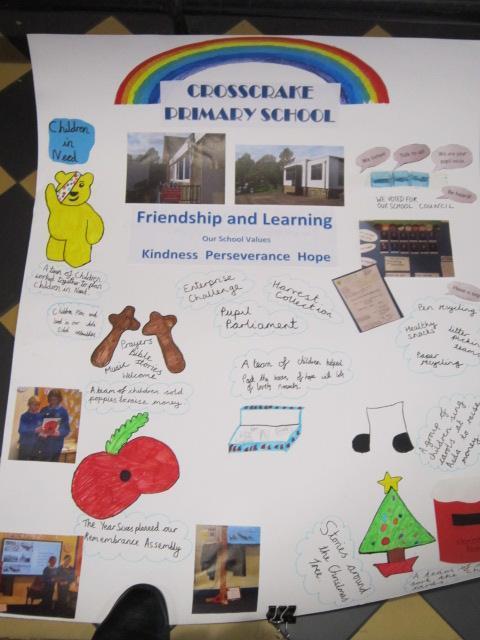 A colourful school display board from Crosscraake Primary School, highlighting school values, achievements, and activities with text, drawings, and photos.